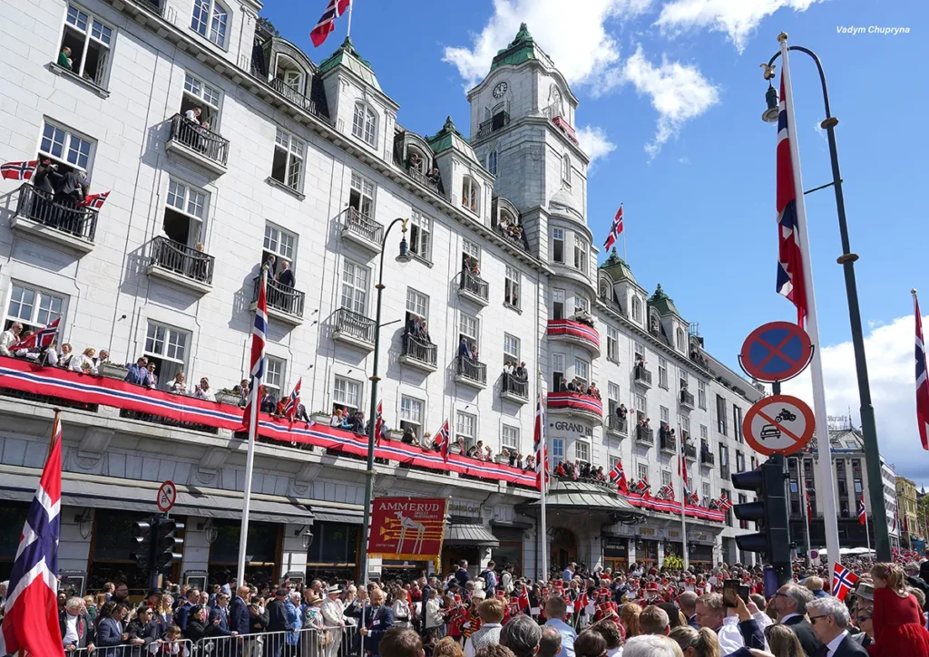 Wide view of Grand Hotel with guests watching the parade from balconies on National Day in Oslo Norway on May 17th 2026