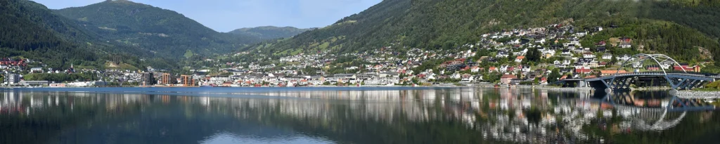 Panoramic view of mountains, fjord, and local architecture in Sogndal, Vestland, Norway