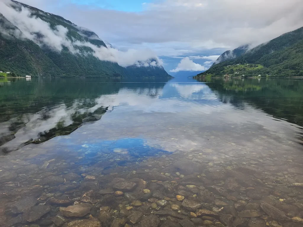 Stunning long shot of the majestic Norwegian highlands and deep waters at Lustrafjorden fjord during summer.