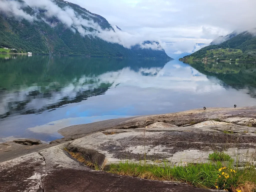 Stunning long shot of the majestic Norwegian highlands and deep waters at Lustrafjorden fjord during summer.